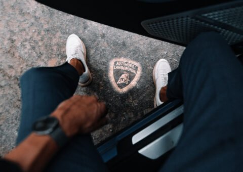 View of ground under car door with Lamnorghini logo projection